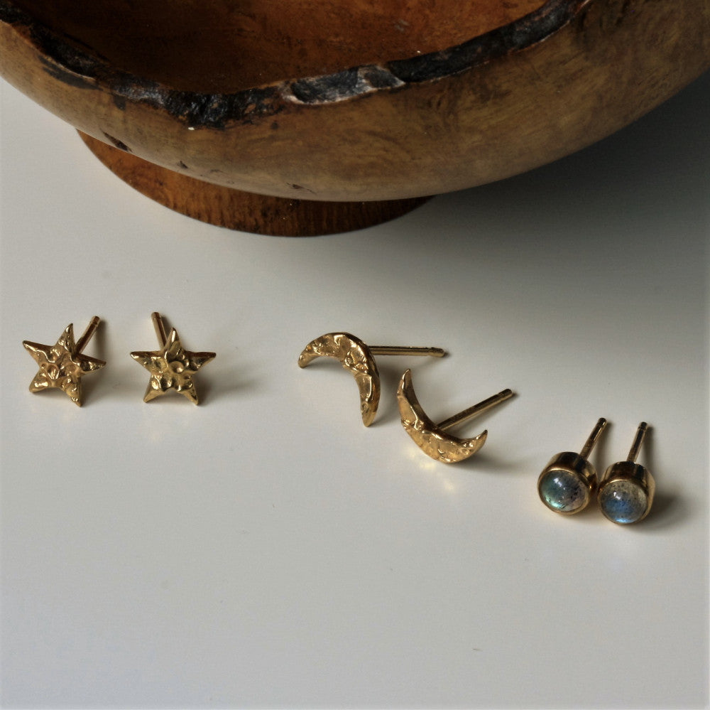 a selection of universe gold stud earrings