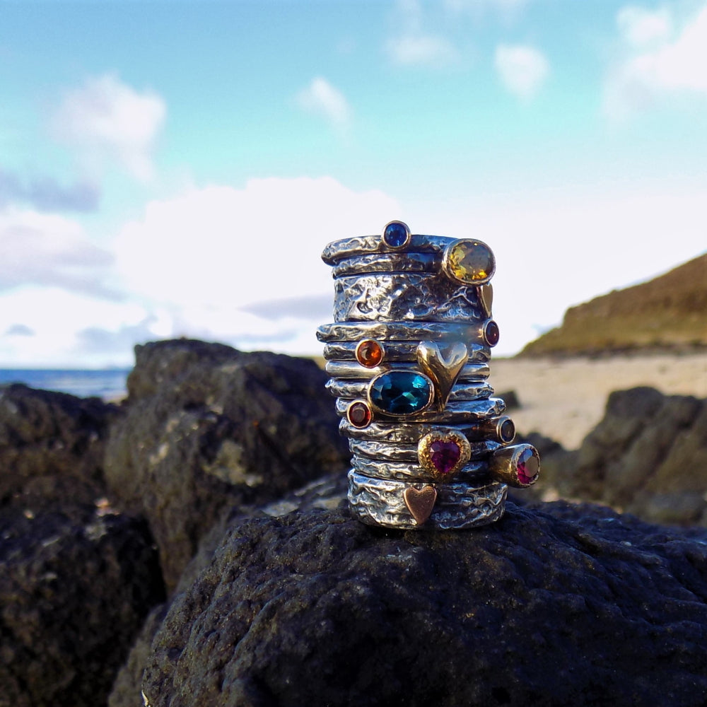 A huge stack of beautiful gemstone treasure silver and gold rings