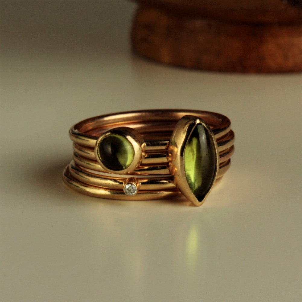 handmade solid gold peridot gemstone and diamond stacking rings for August birthstone 
