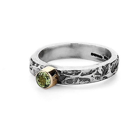 Peridot round green gemstone on a oxidized silver and gold ring