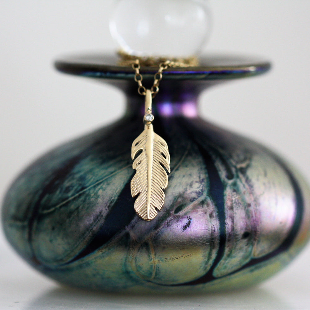 Single Diamond and gold feather necklace