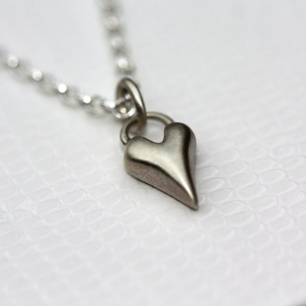 A dainty solid silver handmade wild at heart necklace