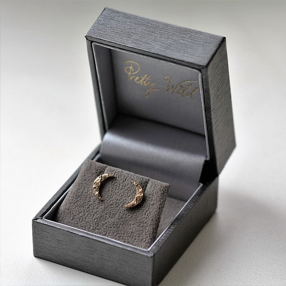 Gold textured moon stud earrings in our branded luxury box