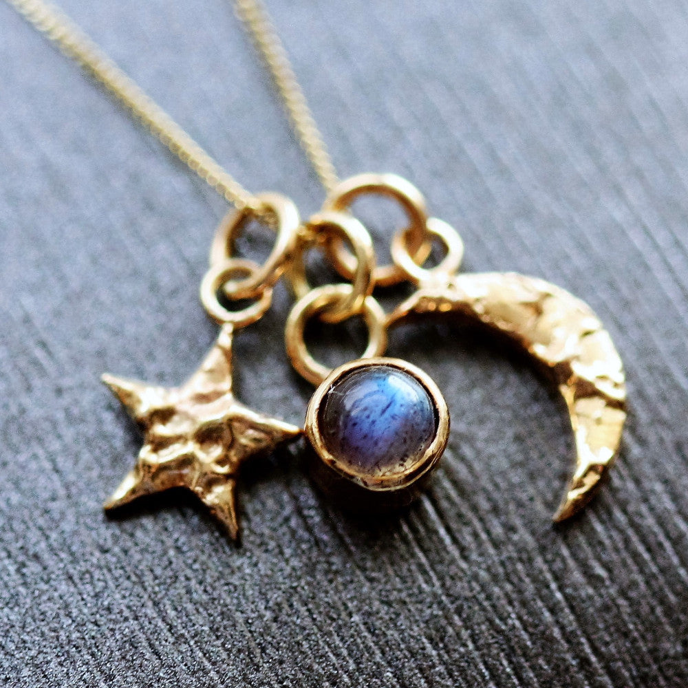 A stunning solid gold dainty moon, star and labradorite charm necklace