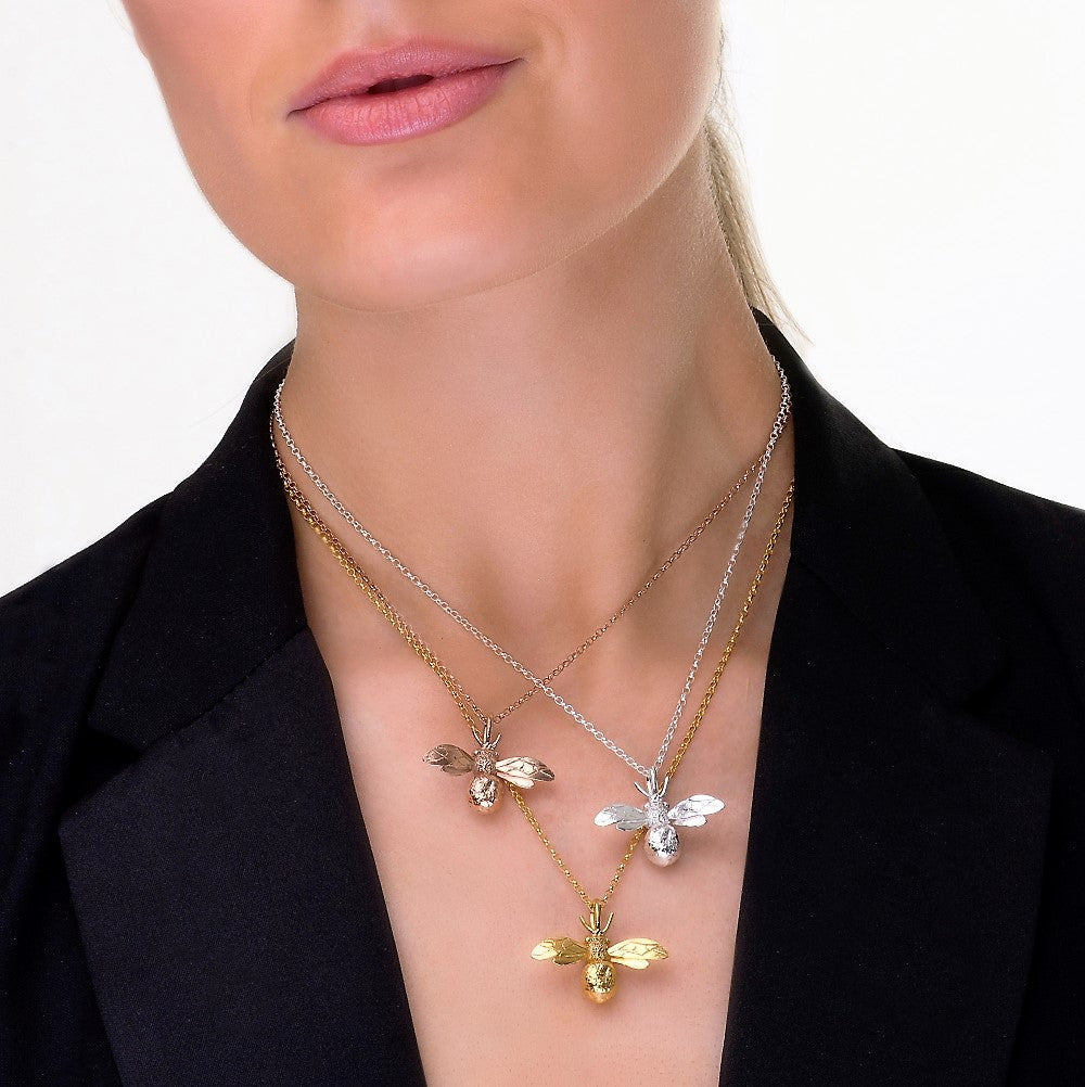 Model wearing sterling silver, rose gold and yellow gold gilded designer bumble bee necklace